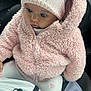 baby, child, pink_jacket, knit_hat, bear_ears, car_seat, curious, cute, warm_clothing, cozy, pastel_colors, infant, winter_wear, soft_texture, hooded_jacket, sitting, closeup, adorable, indoor, portrait