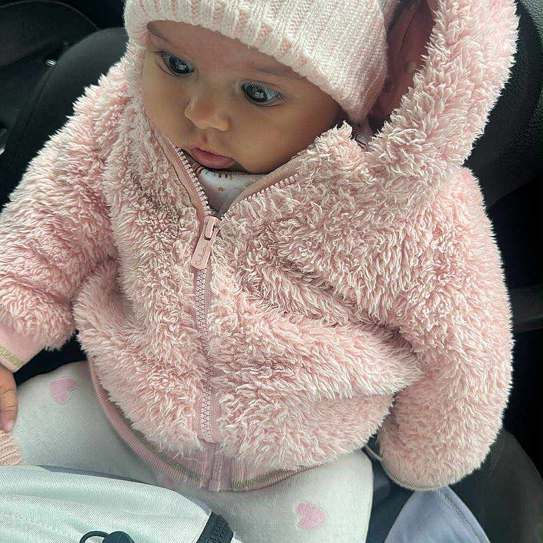 Maïssoum participe au concours pour gagner de l'argent avec cette photo : adorable, baby, bear_ears, car_seat, child, closeup, cozy, curious, cute, hooded_jacket, indoor, infant, knit_hat, pastel_colors, pink_jacket, portrait, sitting, soft_texture, warm_clothing, winter_wear
