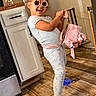 Heaven joined the competition — help win amazing prizes! child, sunglasses, pajamas, pink_purse, blue_gloves, indoor, kitchen, flooring, wooden_floor, cabinet, smiling, playful, fashion, person, pose, accessory, home, happy, cute, toddler