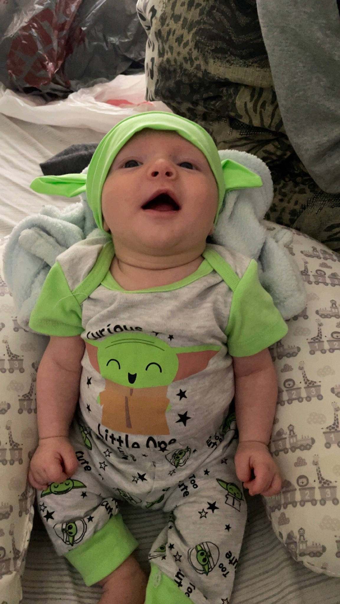 Jonathan is registered to the contest to win money with this photo: baby, baby_toddler_clothing, cap, cheek, child, comfort, facial_expression, fun, grass, green, happy, linens, pattern, person, product, sitting, skin, sleeve, smile, toddler