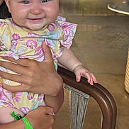 Esmae joined the competition — help win amazing prizes! baby, infant, smile, child, person, hand, arm, face, clothing, sitting, indoor, furniture, chair, skin, leg, adult, holding, cute, happy, portrait