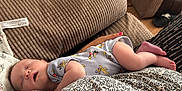 Lucas is registered to the contest to win money with this photo: baby, cartoon_print, casual, closeup, comfort, cushion, fabric, feet, hand, indoor, infant, nail_polish, onesie, pattern, person, relaxation, rest, skin, sleeping, texture