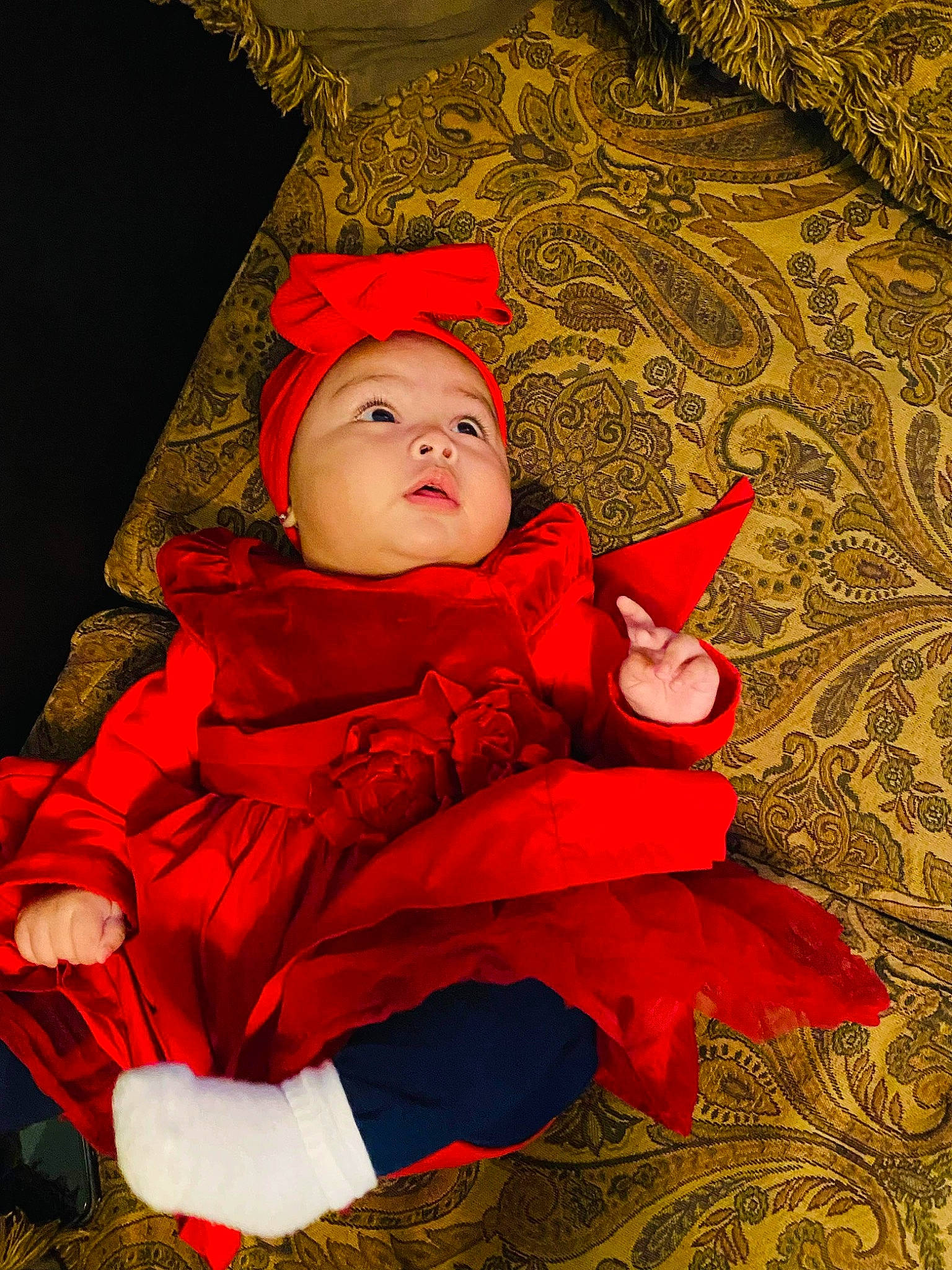 Lexie is registered to the contest to win money with this photo: baby, baby_toddler_clothing, cheek, child, christmas, christmas_eve, christmas_ornament, costume_hat, event, fictional_character, grass, happy, headgear, headwear, lap, person, plant, sitting, skin, toddler