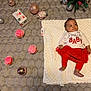 Alani is registered to the contest to win money with this photo: baby, blanket, celebration, christmas_ornaments, christmas_tree, cupcakes, cute, decorations, festive_clothing, floor, holiday, holiday_gifts, holiday_season, indoor, infant, pink_frosting, red_skirt, relaxed, smiling, white_shirt