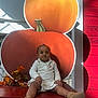 autumn_leaves, baby, bench, booties, child, cute, decoration, fall, holiday, indoor, nike, person, portrait, pumpkin, red_wood, shadow, sitting, smiling, sunlight, white_outfit
