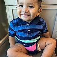 Adan joined the competition — help win amazing prizes! toddler, child, smile, striped_shirt, polo_shirt, sitting, seat, legs, barefoot, indoor, cute, happy, face, short_hair, skin, young_child, portrait, casual, light, background
