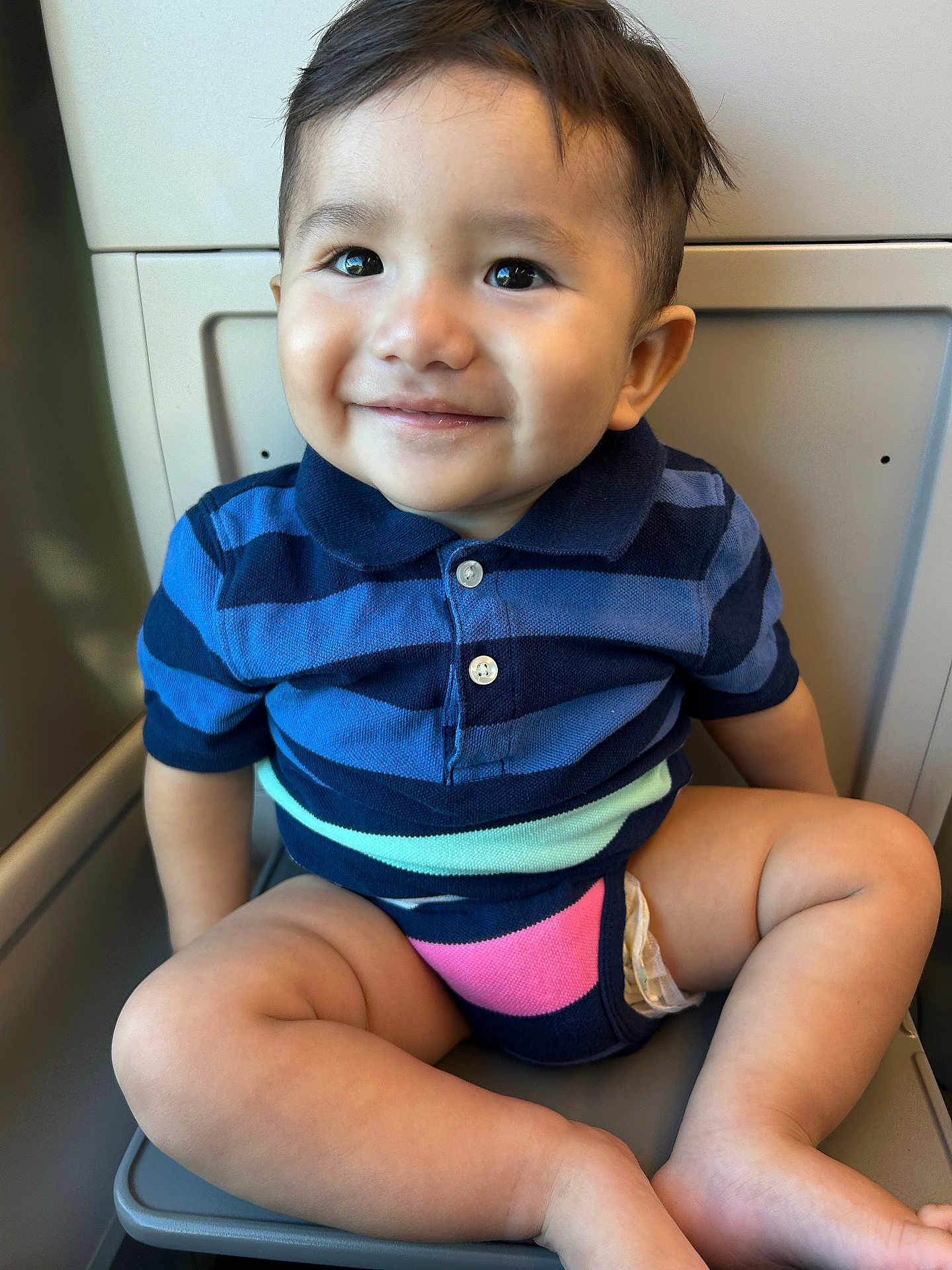 Adan joined the competition — help win amazing prizes! toddler, child, smile, striped_shirt, polo_shirt, sitting, seat, legs, barefoot, indoor, cute, happy, face, short_hair, skin, young_child, portrait, casual, light, background