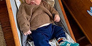 Sonny joined the competition — help win amazing prizes! baby, infant, child, sweater, pants, socks, sneakers, baby_rocker, wooden_floor, toy_chest, stuffed_animal, blanket, indoor, floor, furniture, person, cute, cozy, childrens_room, smiling