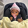 Miela joined the competition — help win amazing prizes! baby, infant, child, stroller, car_seat, pacifier, knit_hat, blanket, pink, black, seated, buckled, portrait, indoors, tile_floor, wide_eyed, face, hands, cozy, photography