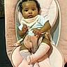 baby, baby_chair, bib, blanket, child, curly_hair, front_facing, furniture, indoors, infant, pacifier_clip, photography, pink, portrait, relaxed, rocker, sitting, socks, white_clothing, wide_eyed