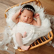 Daleyza joined the competition — help win amazing prizes! newborn, baby, sleeping, basket, white_fabric, pearls, flowers, headband, wooden_floor, cozy, wrapped, infant, peaceful, cute, resting, soft, decorative, tulle, portrait, indoors