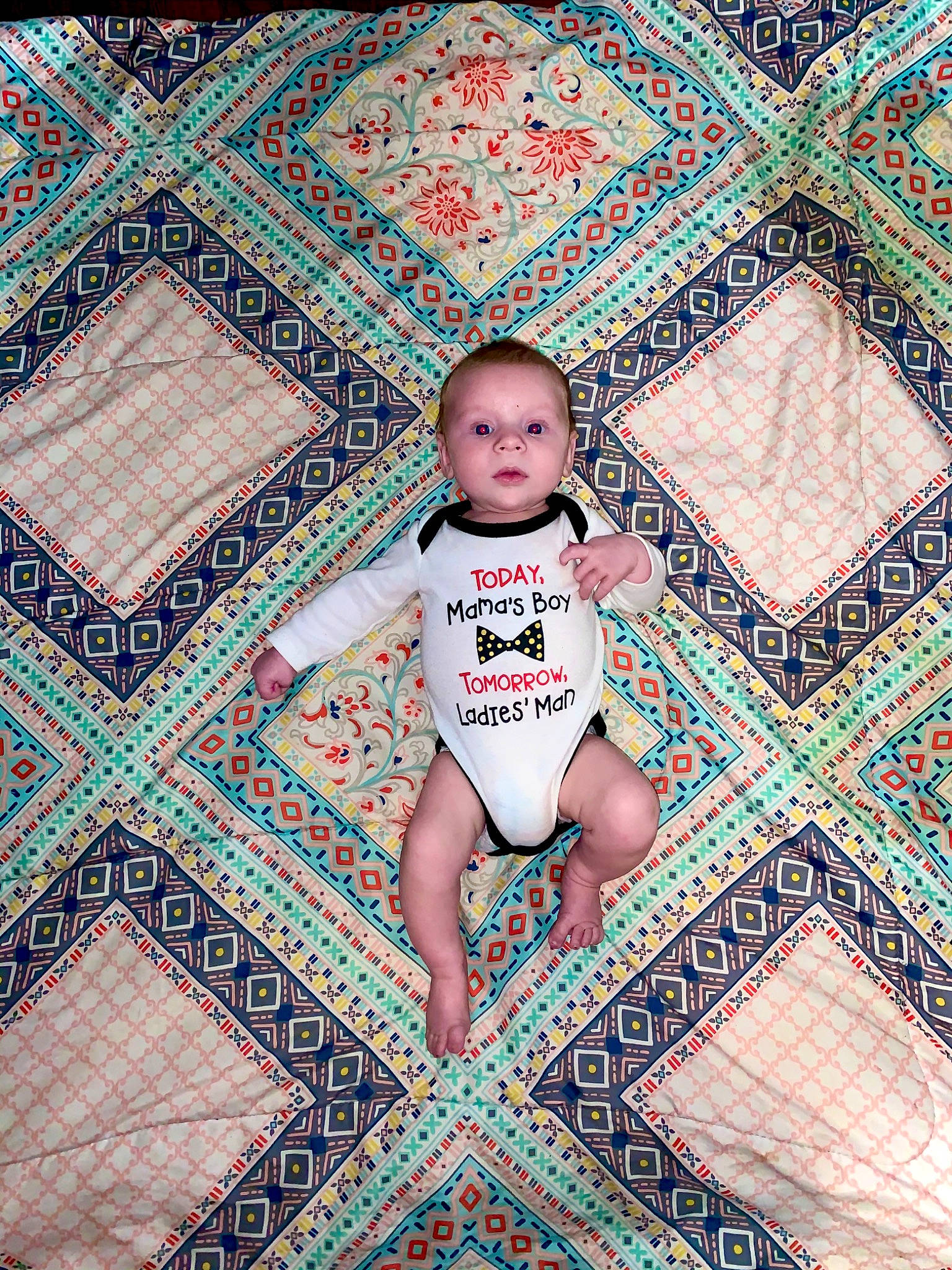 Langston is registered to the contest to win money with this photo: art, child, floor, flooring, pattern, person, quilt, symmetry, textile, turquoise, visual_arts