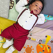Jahyan participe au concours pour gagner de l'argent avec cette photo : adorable, baby, child, colorful, cute, footwear, head, indoors, infant, lying_down, maroon_shorts, maroon_suspender, patterned_mat, pillow, play_mat, portrait, relaxed, small_hands, sneakers, white_shirt