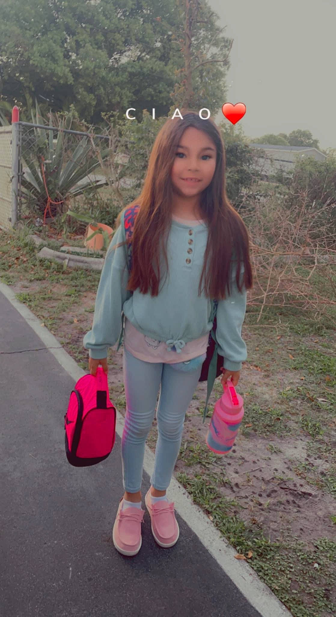 Ava is registered to the contest to win money with this photo: bag, eyewear, fawn, hairstyle, happy, joy, knee, leg, lip, long_hair, luggage_and_bags, magenta, person, pink, plant, red, shoe, sleeve, t_shirt, thigh