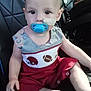 baby, child, pacifier, car_seat, medical_bandage, red_outfit, football_theme, sitting, indoor, cute, face, head, hand, foot, person, clothing, infant, young_child, seat, transport
