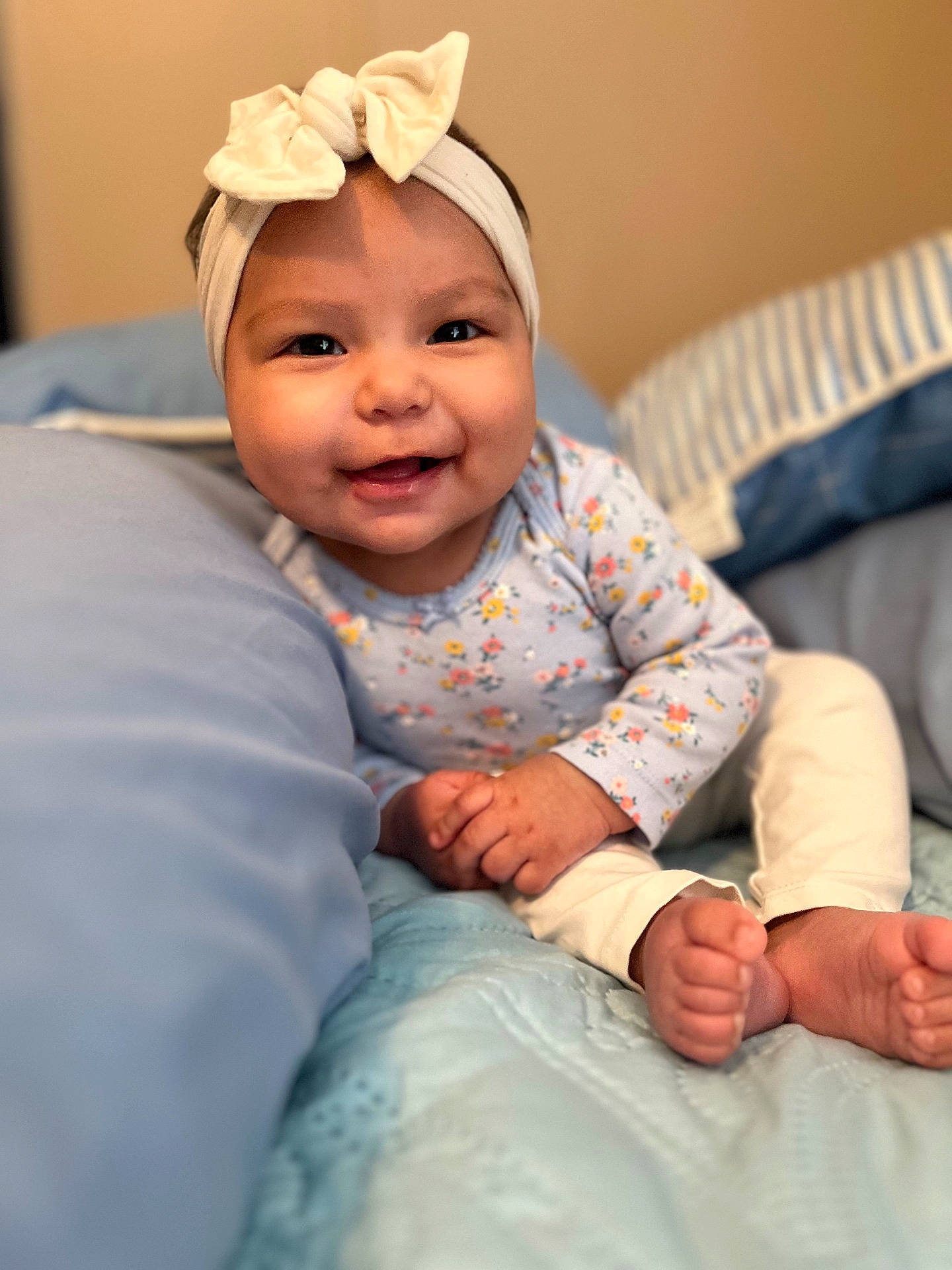 Aylani is registered to the contest to win money with this photo: accessories, baby, babylaughing, bed, bodypart, clothing, cushion, face, finger, furniture, hand, happy, head, homedecor, indoors, pants, person, photography, portrait, smile