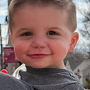Jaxson joined the competition — help win amazing prizes! child, toddler, smile, face, haircut, outdoor, blue_sky, tree, clothing, nike_logo, person, portrait, daylight, happy, cute, holding, head, shoulder, casual_wear, background