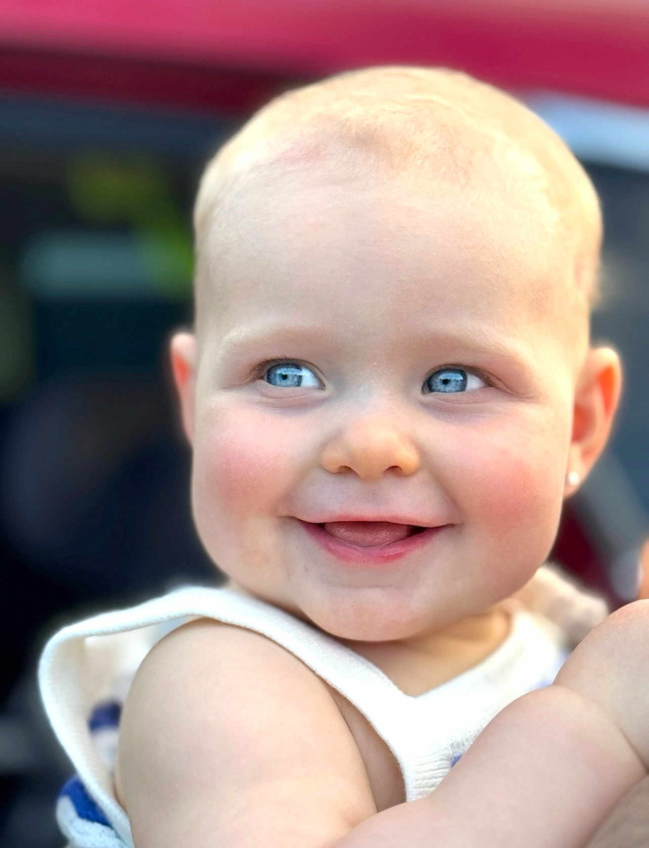 Delilah is registered to the contest to win money with this photo: baby, child, smiling, face, blue_eyes, skin, cheeks, arm, clothing, white_outfit, portrait, cute, happy, closeup, infant, people, young_child, human, expression, natural_light