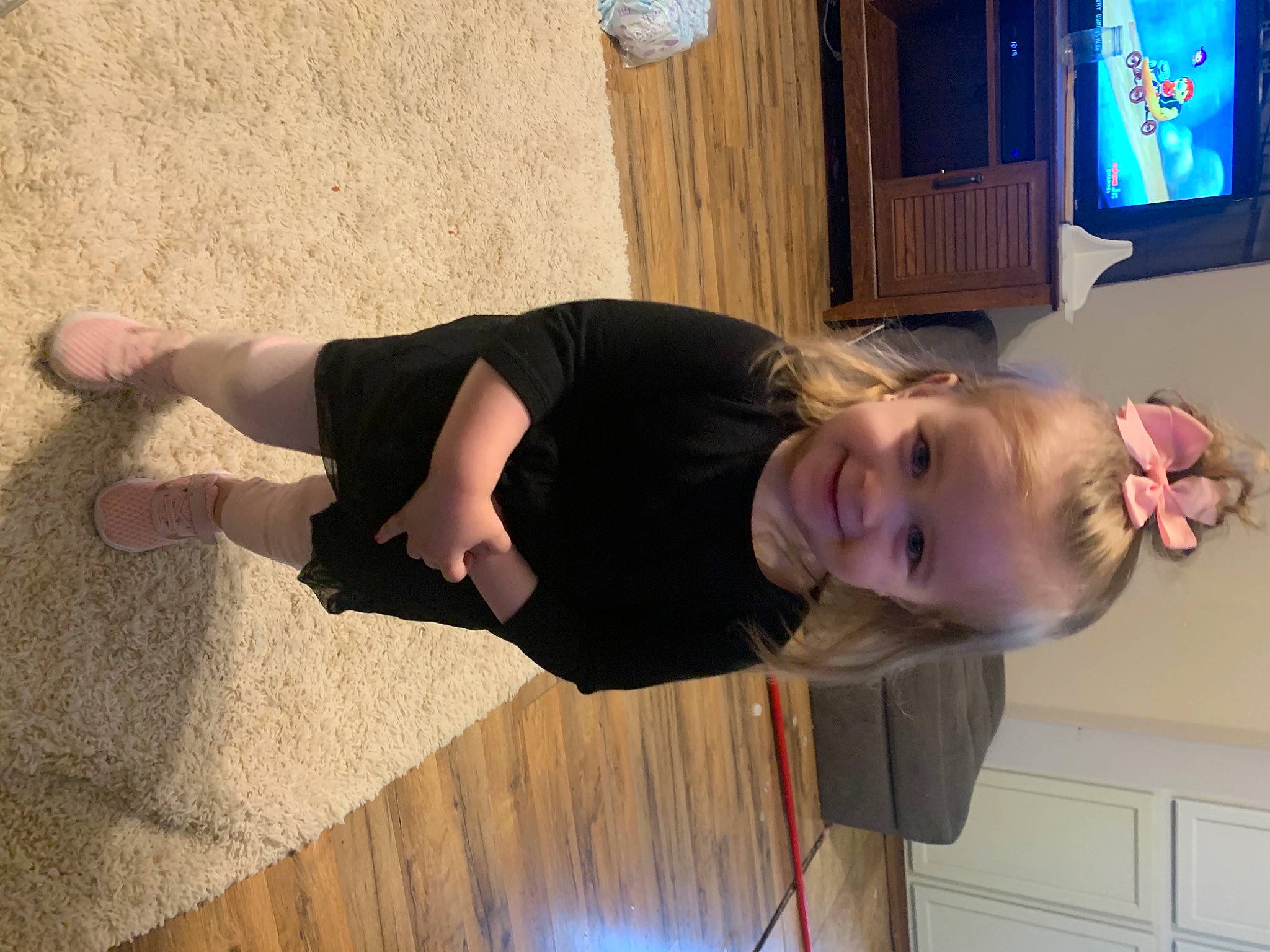 Ella is registered to the contest to win money with this photo: child, elbow, finger, flooring, fun, gesture, happy, hardwood, head, joint, joy, person, shoulder, smile, television, thigh, thumb, toddler, varnish, wood