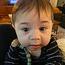 Micah joined the competition — help win amazing prizes! baby, child, face, eyes, striped_clothing, indoor, person, portrait, cute, young, infant, curious, closeup, head, skin, hair, furniture, living_room, table, toy