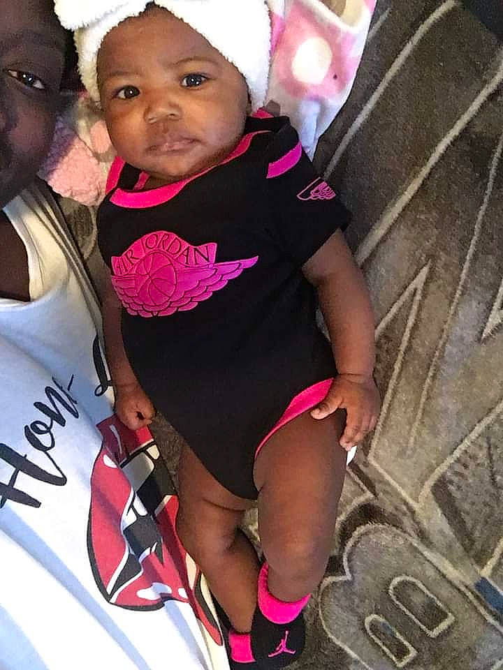 Ky'Una is registered to the contest to win money with this photo: baby, baby_toddler_clothing, black_hair, clothing, cool, face, facial_expression, happy, headgear, leg, lip, magenta, mouth, muscle, person, pink, purple, skin, sleeve, thigh