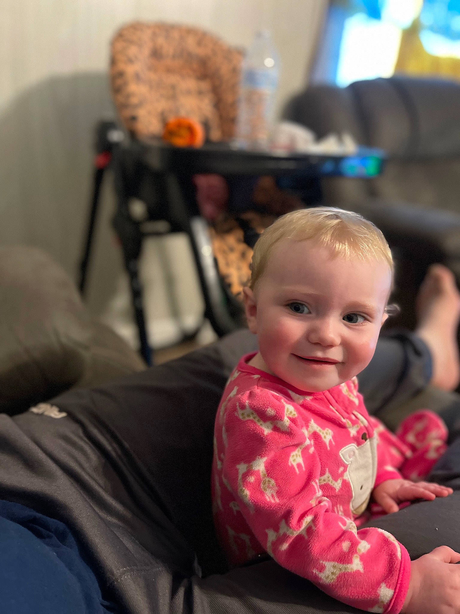 Jolena is registered to the contest to win money with this photo: baby, baby_toddler_clothing, chair, cheek, child, comfort, event, flooring, fun, hairstyle, happy, joy, lap, leisure, living_room, magenta, person, room, sitting, smile