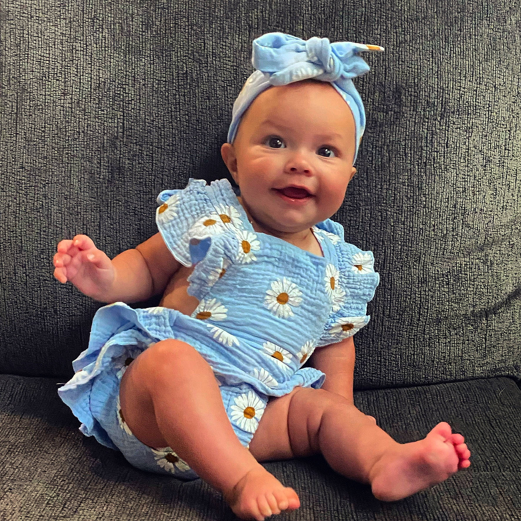 Billie is registered to the contest to win money with this photo: baby, baby_toddler_clothing, barefoot, cap, cheek, costume_hat, dress, eye, face, finger, foot, fun, happy, head, human_body, leg, person, skin, sleeve, smile