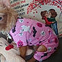 dog, pet, costume, pink_clothing, plush_toy, couch, pillow, illustration, text, indoor, small_dog, brown_fur, stuffed_animal, decor, heart, tree, people_illustration, fabric, sewing, cute