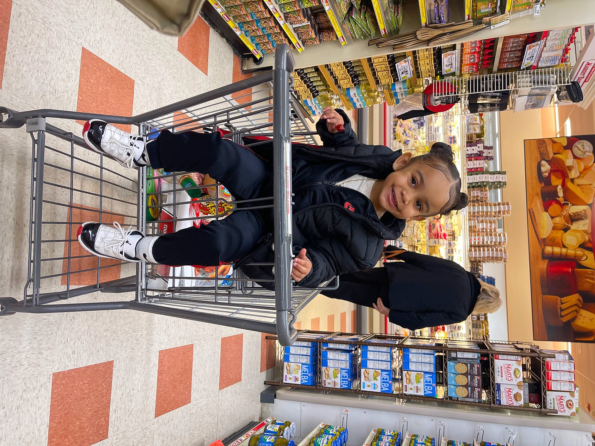 Delilah joined the competition — help win amazing prizes! building, child, collection, convenience_store, customer, fun, joy, leisure, person, publication, recreation, retail, room, shelf, shelving, smile, t_shirt, toy