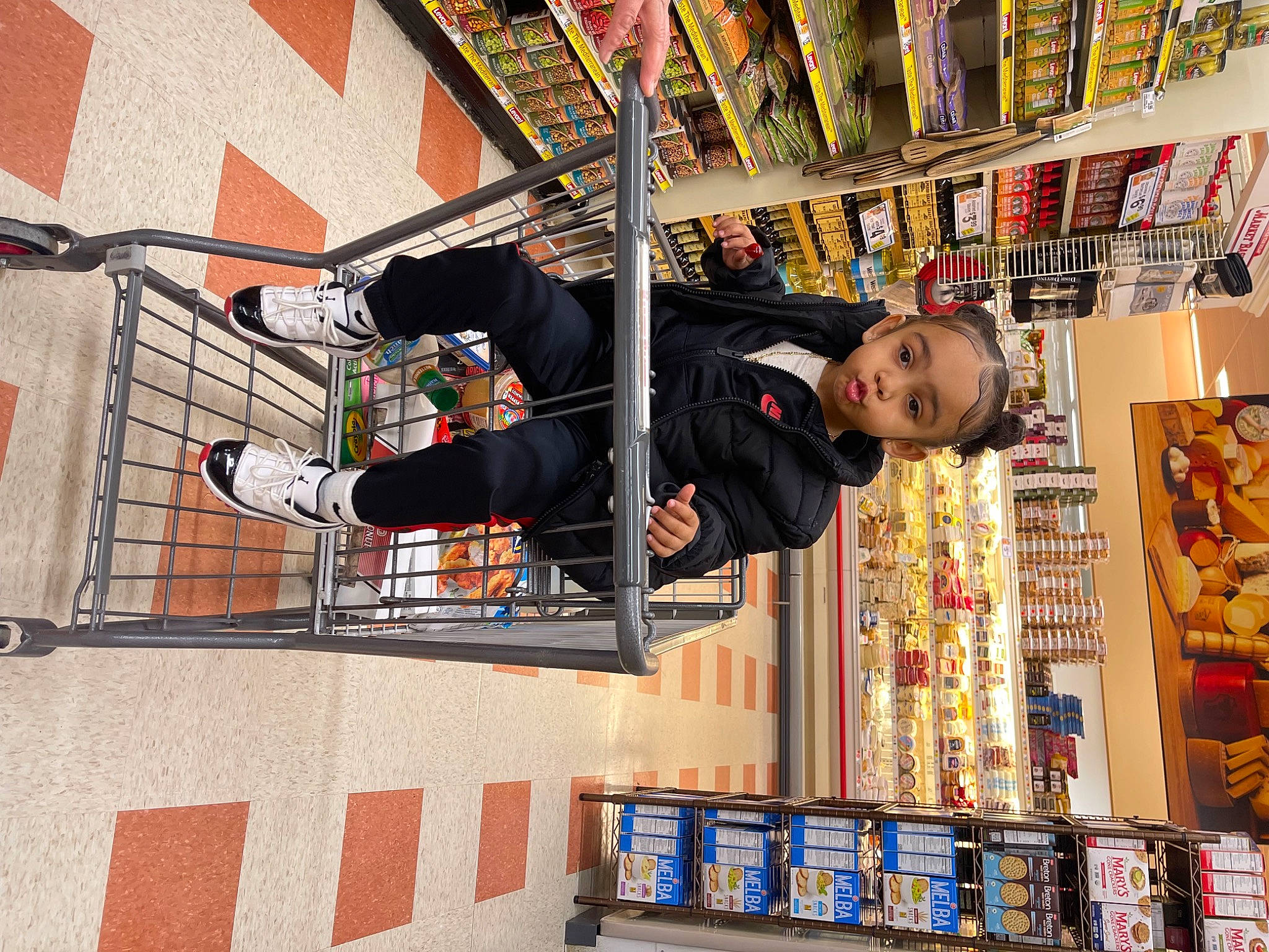 Delilah joined the competition — help win amazing prizes! bookcase, building, child, collection, convenience_store, customer, facade, flooring, fun, grocery_store, library, person, publication, recreation, retail, room, shelf, shelving, t_shirt, toy