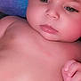 baby, infant, face, skin, chubby_cheeks, lying_down, colorful_background, soft_texture, hand, torso, belly_button, calm, cute, newborn, portrait, indoors, closeup, child, young, expression