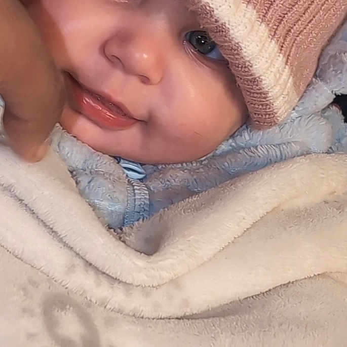 Marceline Mcelroy is registered to the contest to win money with this photo: baby, blanket, bonnet, cap, clothing, crying, face, happy, hat, head, hood, newborn, person, photography, portrait, sad, smile
