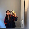 bathroom, casual_clothing, cat, cute, electrical_outlet, hand, kitten, light, long_hair, mirror, pet, phone, reflection, selfie, sink, smile, toothbrush, toothpaste, wall, woman