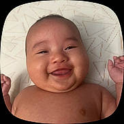 Nayeli is registered to the contest to win money with this photo: adorable, baby, bare_chest, child, chubby_cheeks, closeup, cute, cute_expression, face, hand, happy, infant, joyful, lying_down, patterned_background, portrait, skin, smiling, tongue_out, young