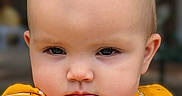 Stevie joined the competition — help win amazing prizes! apparel, baby, baby_fashion, child, closeup, cute, ears, eyes, face, fashion, giraffe_pattern, head, infant, outdoor, person, portrait, serious_expression, skin, yellow_clothing, young_child