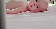 Stevie joined the competition — help win amazing prizes! baby, blanket, child, crib, cute, decor, expression, face, head, indoors, infant, lying_down, nursery, peaceful, pink, room, skin, soft_toys, stuffed_animals, toy
