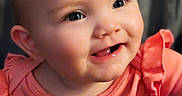 Stevie joined the competition — help win amazing prizes! apparel, baby, cartoon_character, cheeks, child, closeup, cute, expression, eyes, face, happy, head, indoors, infant, person, pink_clothing, portrait, sitting, smiling, young_child