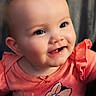 baby, child, smiling, face, portrait, pink_clothing, cute, infant, happy, closeup, person, young_child, indoors, apparel, head, expression, eyes, cheeks, sitting, cartoon_character
