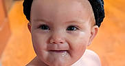 Stevie is registered to the contest to win money with this photo: baby, cat_ears, child, closeup, cute, drool, expression, eyes, face, happy, headband, headwear, indoors, infant, person, portrait, skin, soft_light, warm_tone, young