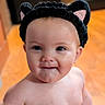 Stevie is registered to the contest to win money with this photo: baby, cat_ears, child, closeup, cute, drool, expression, eyes, face, happy, headband, headwear, indoors, infant, person, portrait, skin, soft_light, warm_tone, young