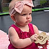 Stevie is registered to the contest to win money with this photo: baby, infant, child, pink_bow, headband, fuchsia_dress, plaque, 8_months, outdoor, blanket, trampoline, grass, serious_expression, sitting, cute, portrait, person, young_child, summer, daytime
