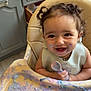 toddler, high_chair, messy, food, spoon, smiling, curly_hair, kitchen, baby, face_paint, happy, colorful, child, feeding, playful, cute, indoor, bib, table, expression