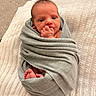 newborn, baby, infant, child, portrait, swaddled, blanket, gray_blanket, baby_feet, tiny_hands, fist, hand_to_mouth, wide_eyed, lying_down, cozy, indoor, bed, textile, closeup, cute
