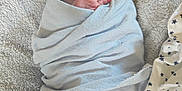 Levi is registered to the contest to win money with this photo: baby, blanket, blue_blanket, child, clothing, cozy, cute, fabric, face, hand, indoors, infant, lying_down, newborn, peaceful, sleeping, soft, star_pattern, texture, wrapped