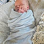 newborn, baby, sleeping, blanket, blue_blanket, hand, face, cozy, soft, texture, fabric, star_pattern, clothing, infant, wrapped, lying_down, peaceful, cute, child, indoors