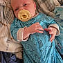 baby, blanket, blue_onesie, child, clothing, cozy, cute, elephant_pattern, face, hands, indoors, infant, lying_down, newborn, pacifier, portrait, resting, sleepy, soft_texture, toddler