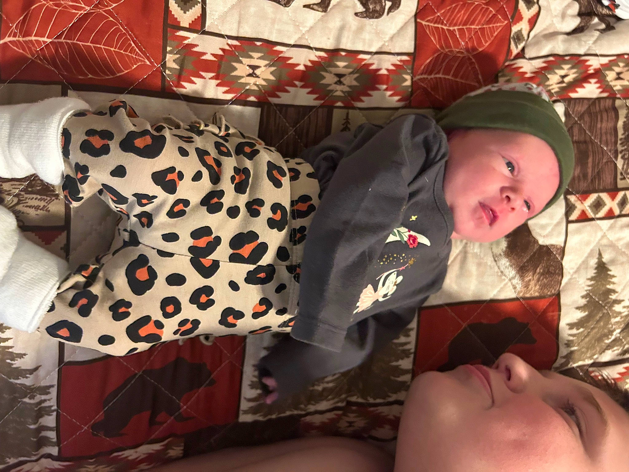 Nicole is registered to the contest to win money with this photo: baby, baby_toddler_clothing, cap, carmine, child, comfort, design, fashion_accessory, happy, headwear, human_leg, lap, linens, pattern, person, plaid, red, room, sleeve, textile