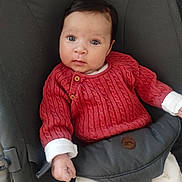 Alma participe au concours pour gagner de l'argent avec cette photo : baby, infant, child, blue_eyes, red_sweater, knitted_clothing, seated, cushioned_seat, hand, fist, white_clothing, patterned_pants, indoor, portrait, cute, young, person, face, looking, expression