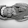 Alma a rejoint le concours — aidez-le/la à gagner de superbes lots ! newborn, baby, wrapped, blanket, hands, flower_headband, black_and_white, portrait, infant, cute, peaceful, small_feet, knitted, tattoo, bracelet, lying_down, soft_texture, human, tenderness, studio