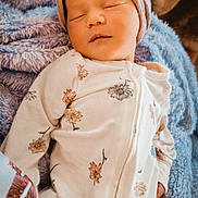 Raelynn is registered to the contest to win money with this photo: baby, sleeping, headband, floral, onesie, blanket, soft, cozy, infant, peaceful, cute, child, portrait, closeup, rest, comfort, warm, skin, face, newborn